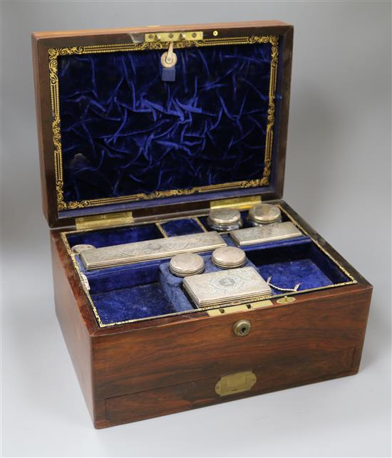 A Victorian travelling rosewood toilet box with seven silver mounted jars, London, 1871 and one other odd jar, box 33cm.